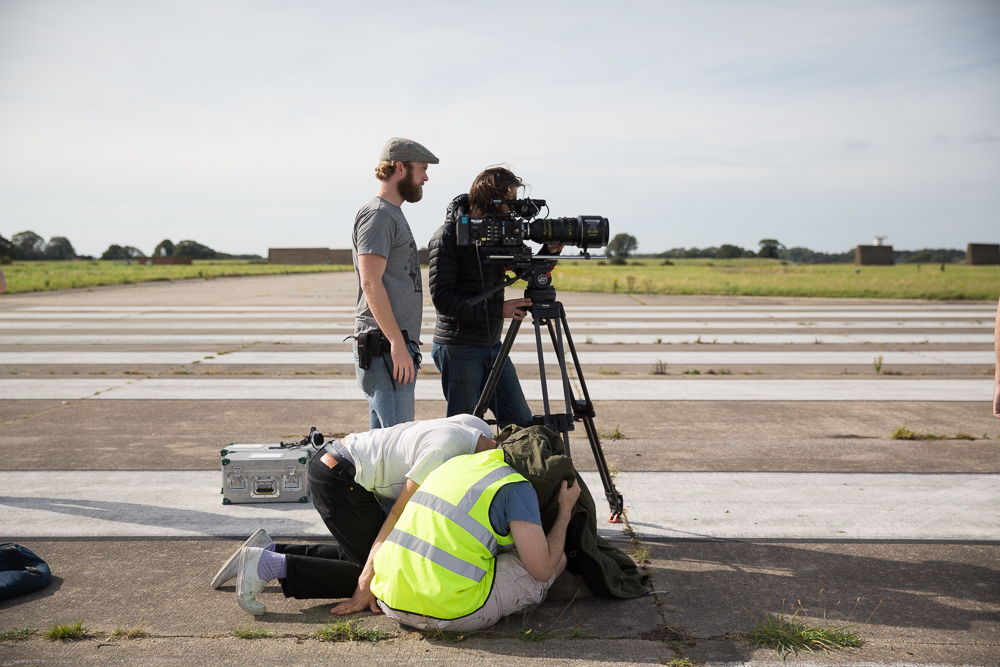 Indie filmmaking crew on set on an airfield