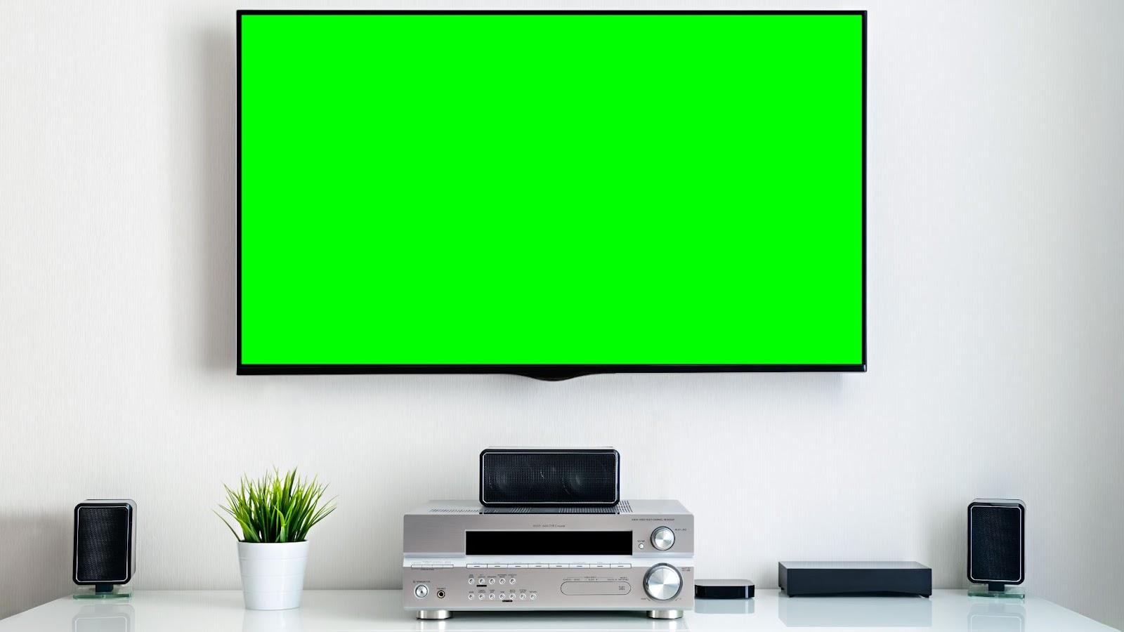 A wall-mounted tv screen with a chromakey green screen placeholder